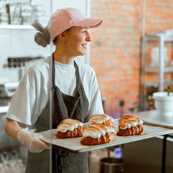 pretty-woman-baker-holds-beautiful-croissants-with-burnt-albumenous-cream-in-shop-1.jpg